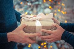 Image of hands passing a wrapped gift