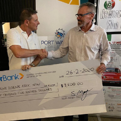 charity cheque presentation with two men at Italian film festival